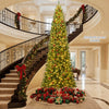 12 ft tall prelit artificial Christmas tree with 2536 branch tips and 1030 LED lights, perfect for grand indoor spaces.