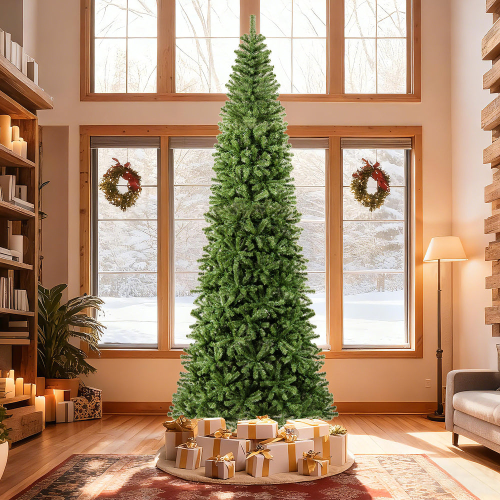 12 ft tall prelit artificial Christmas tree with 2536 PVC branch tips, decorated with gifts, perfect for festive indoor.