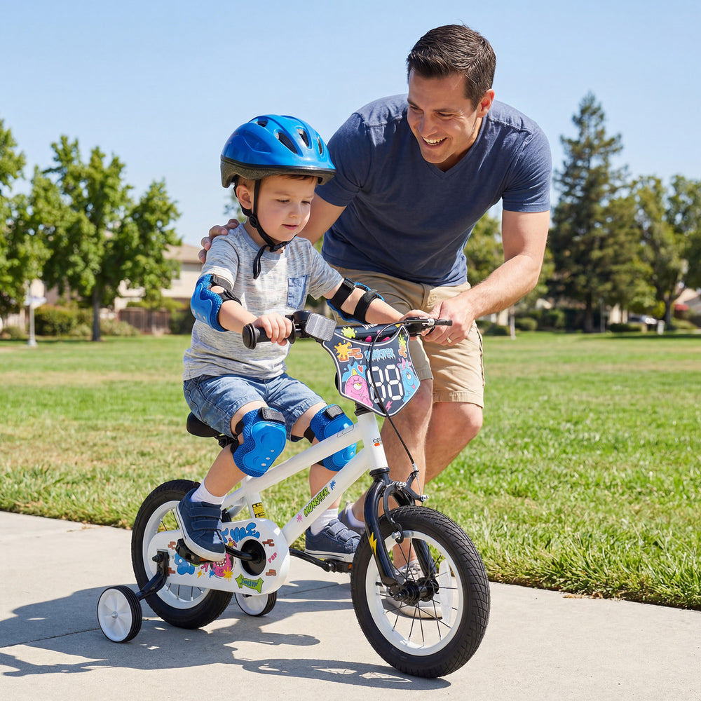 Child riding a 12-inch kids bike with training wheels, featuring bright monster graphics and adjustable seat for ages.