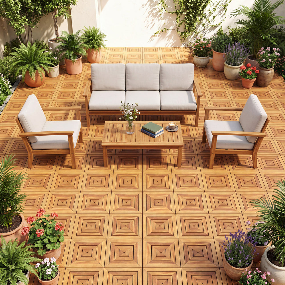 Acacia wood interlocking deck tiles in a natural finish, arranged on a patio with outdoor furniture and plants.