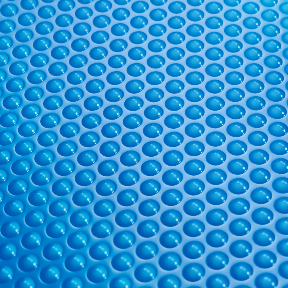 Close-up of a blue bubble cover made from durable PE material, designed to retain heat and reduce pool debris.