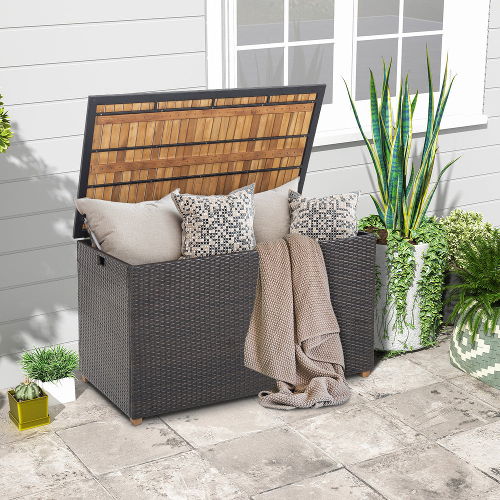 Rattan storage box with acacia wood top, featuring cushions, ideal for patio side table and outdoor storage.