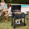 24-inch charcoal grill with 544 sq.in cooking area, featuring 2 folding side tables, in use during a backyard gathering.