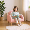 Kids armchair in pink with comfy backrest and armrests, covered in soft teddy fleece, perfect for reading in a cozy.