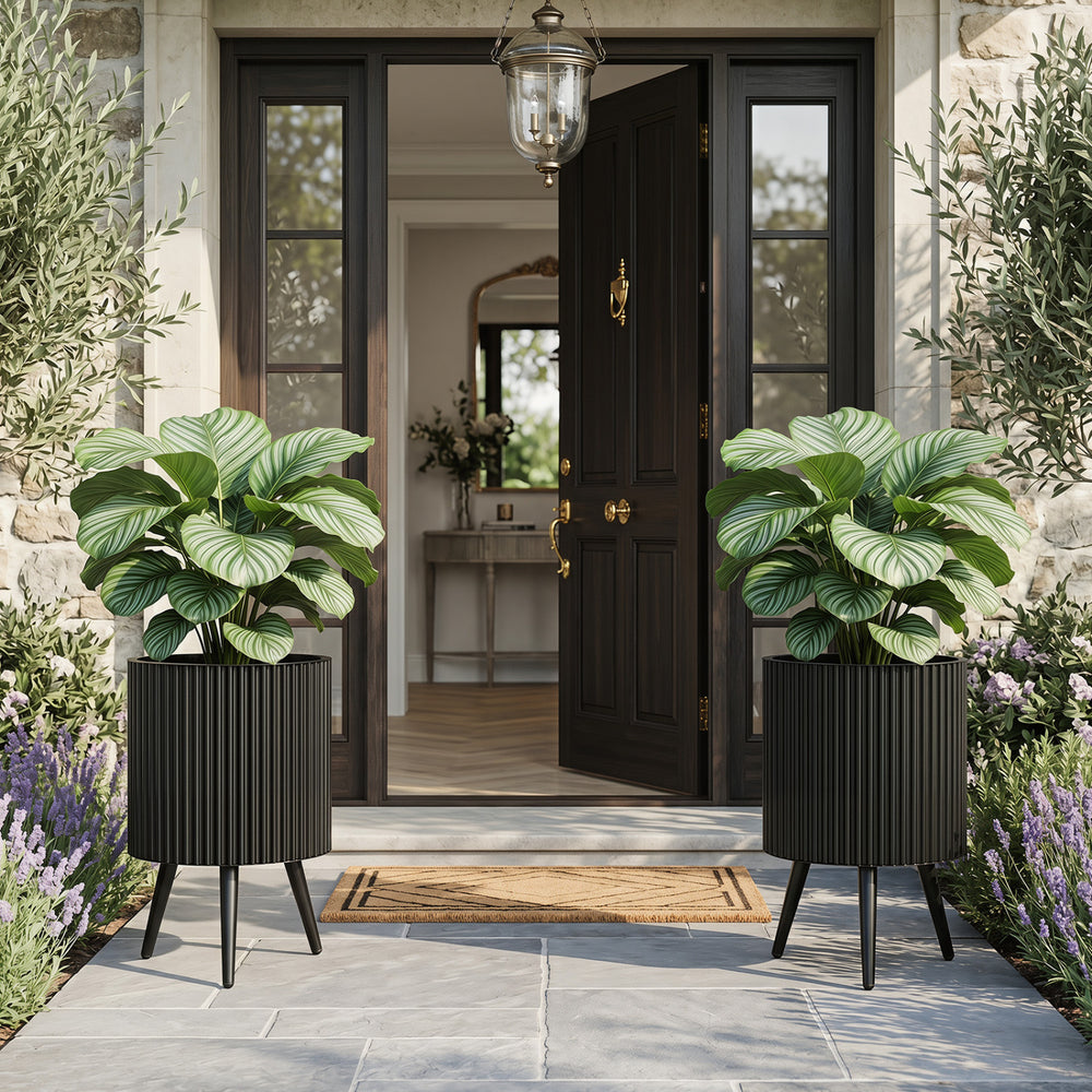 Aesthetic 14-inch fluted metal plant pot with tapered legs, perfect for enhancing indoor or outdoor garden spaces.