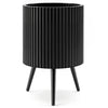 Fluted black metal plant pot with tapered legs, designed for indoor and outdoor use, enhancing plant growth and stability.