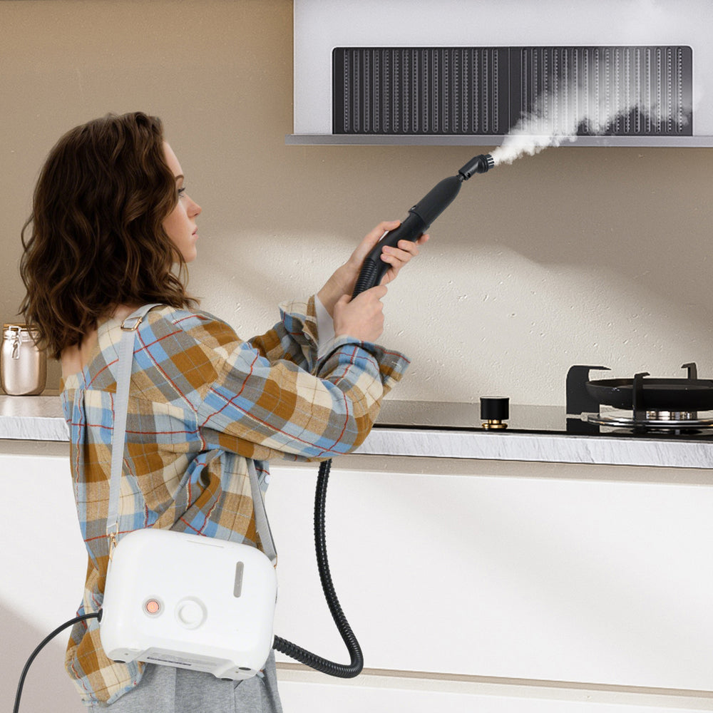 Woman using a 1500W portable steam cleaner with a 34 oz water tank to clean kitchen surfaces effectively.