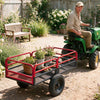 Heavy-duty red metal dump cart trailer with 1540 lbs capacity, ideal for transporting soil and gardening tools.