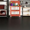 Red tool cart with cleaning supplies in a garage setting, featuring waterproof PE mechanic pads for durable flooring.