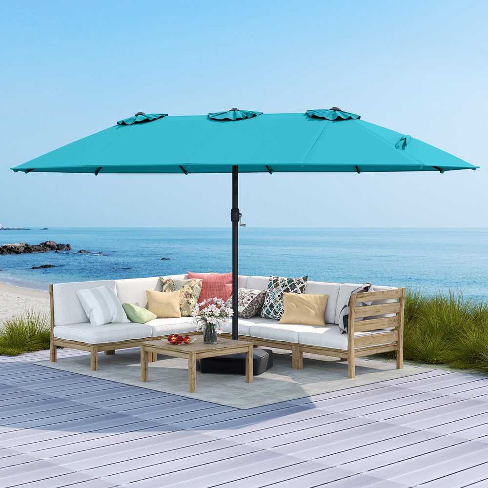 Double-sided 15ft turquoise patio umbrella with metal base, ideal for outdoor shading and stability by the beach.