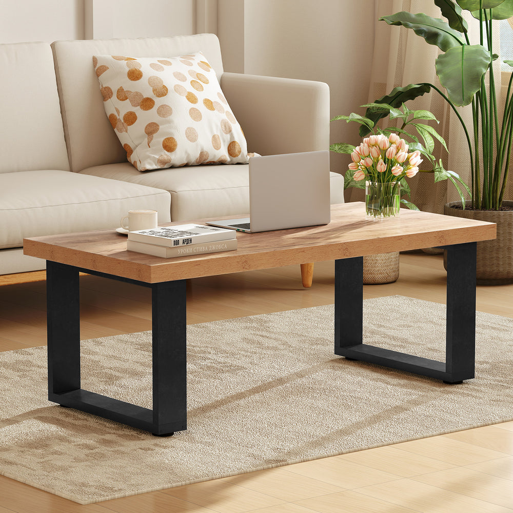 Rustic 47" coffee table with thick oak tabletop and black metal legs, perfect for living room decor and functionality.