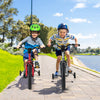 Two kids riding 16-inch bikes with training wheels, featuring handbrake and coaster brake, on a sunny pathway.