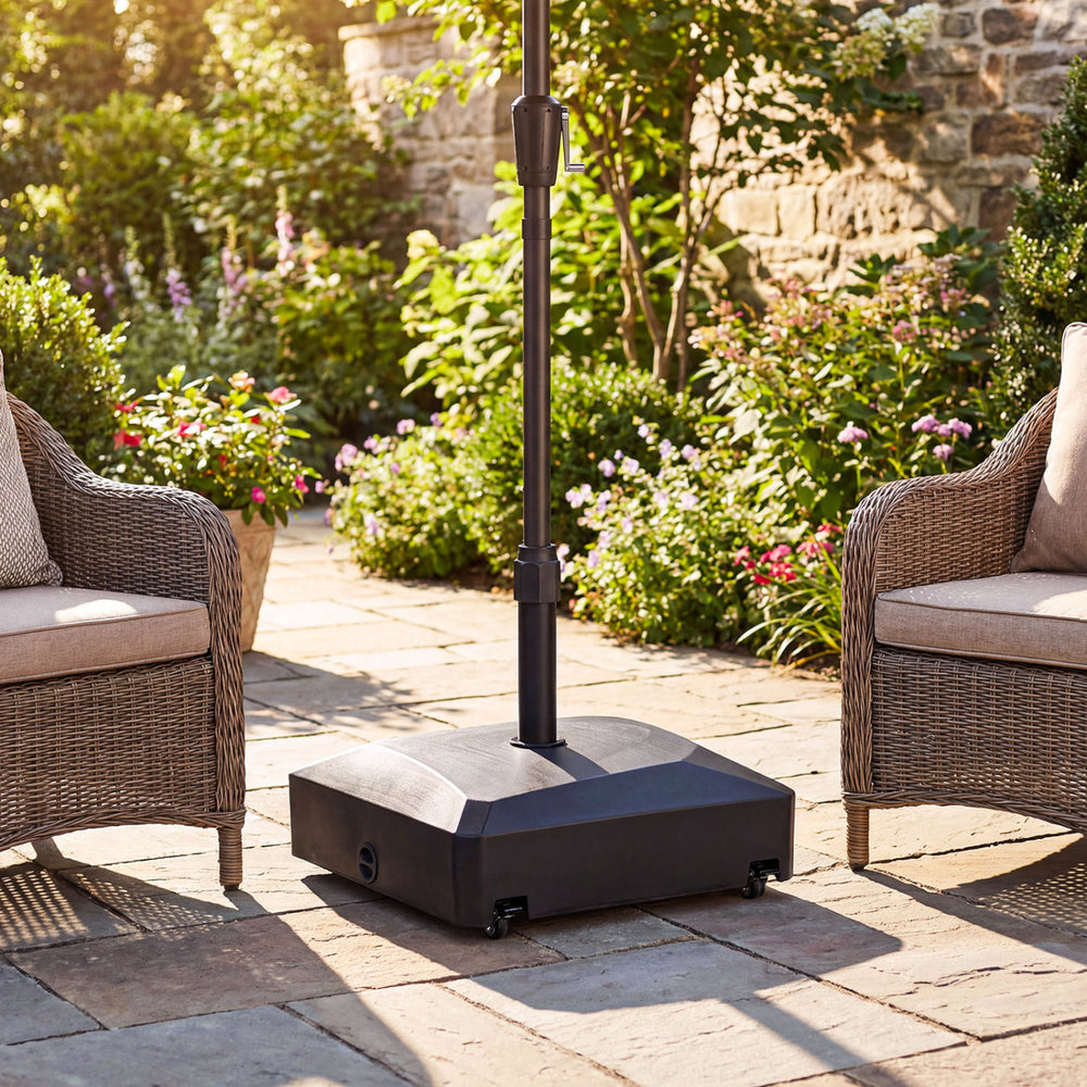Fillable mobile umbrella base with wheels and locks, designed for stability and support in outdoor settings.