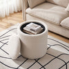 Round beige storage ottoman with a reversible lid, ideal for organizing and serving as a footrest or coffee table.