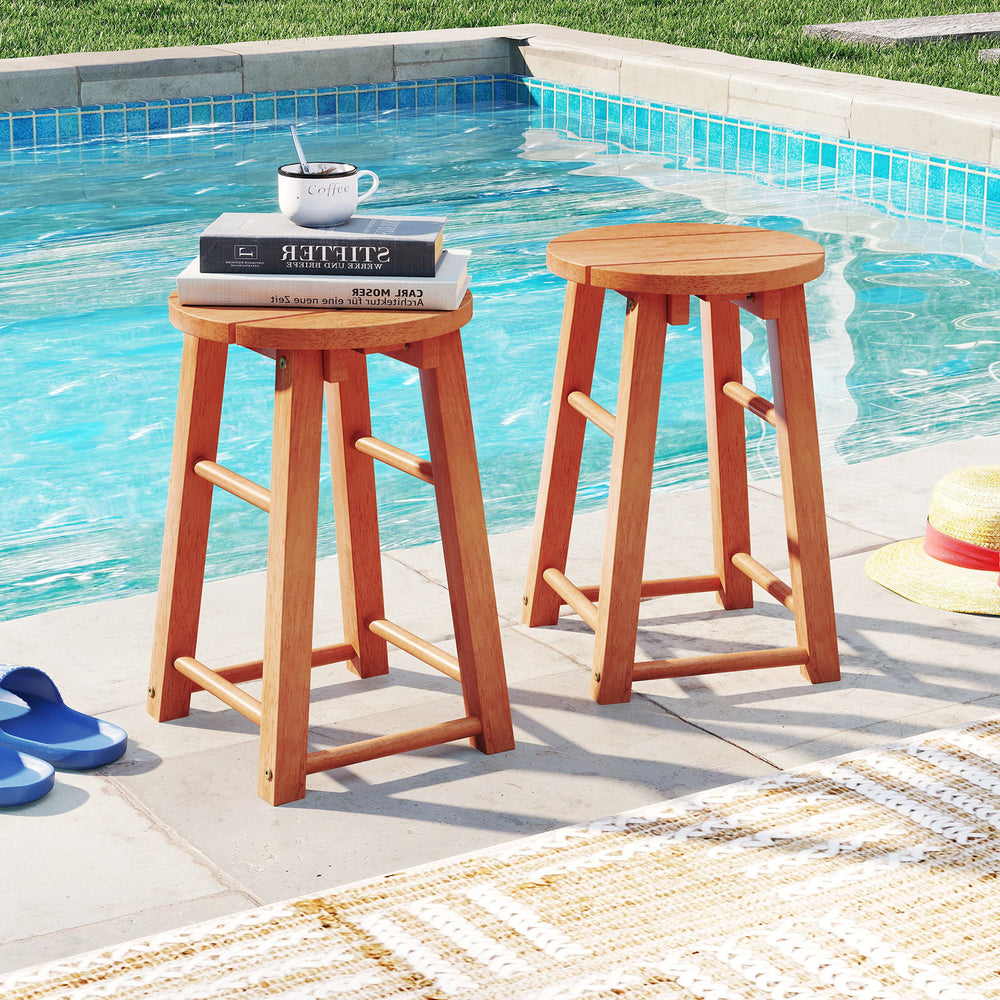 Set of 2 18-inch outdoor wood bar stools with round seats, perfect for poolside or patio use.