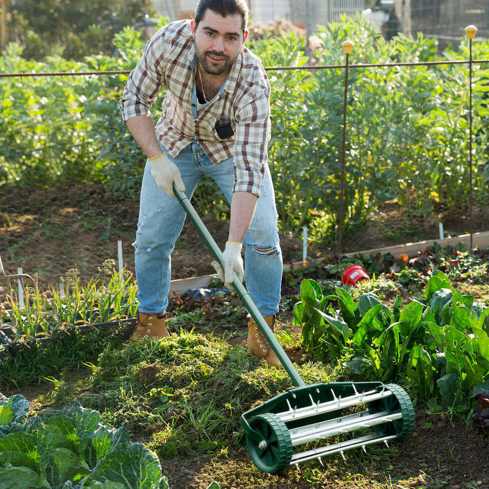 18-inch rolling lawn aerator with protective baffle, designed for easy soil perforation and improved nutrient diffusion.