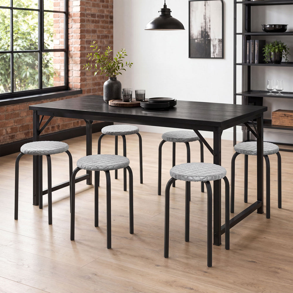 Stackable 18-inch round stools with removable washable covers and heavy-duty metal legs, perfect for dining or classroom use.