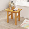 Teak shower bench with solid construction, compact design, ideal for shaving legs or as a side table in the bathroom.