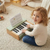 Wooden piano for kids featuring 18 keys and a removable music stand, perfect for toddlers' musical development.