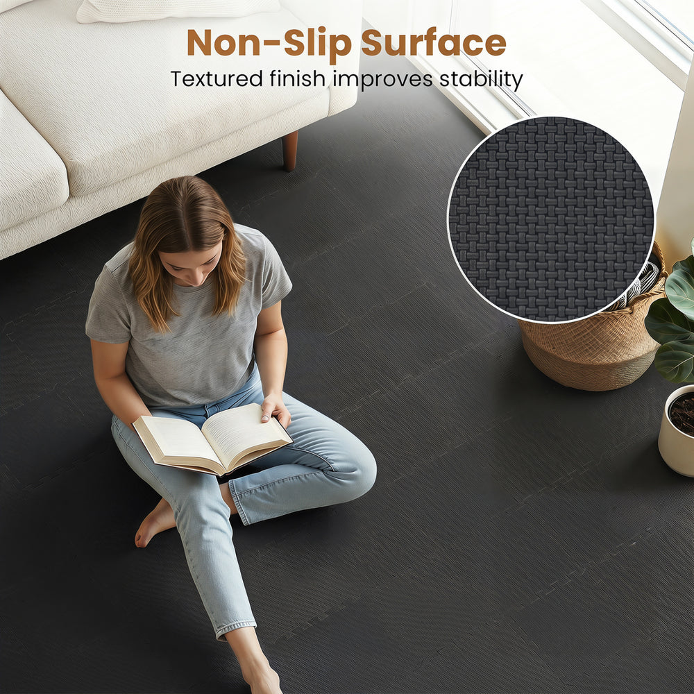 Interlocking black EVA foam floor tiles with a non-slip surface, ideal for home gyms and living spaces.