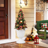 Vintage white planter with pedestal base, perfect for indoor or outdoor use, showcasing a festive tree and decorations.