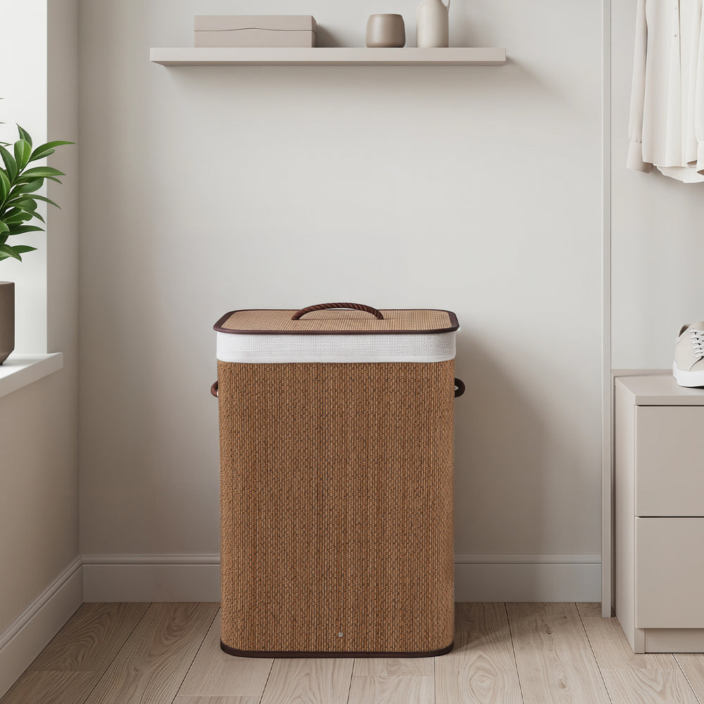 Bamboo clothes hamper with removable liner, 19-gal capacity, portable handles, ideal for bedrooms and laundry rooms.