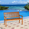 Two-person solid wood garden bench with curved backrest, natural teak color, perfect for outdoor relaxation by the pool.