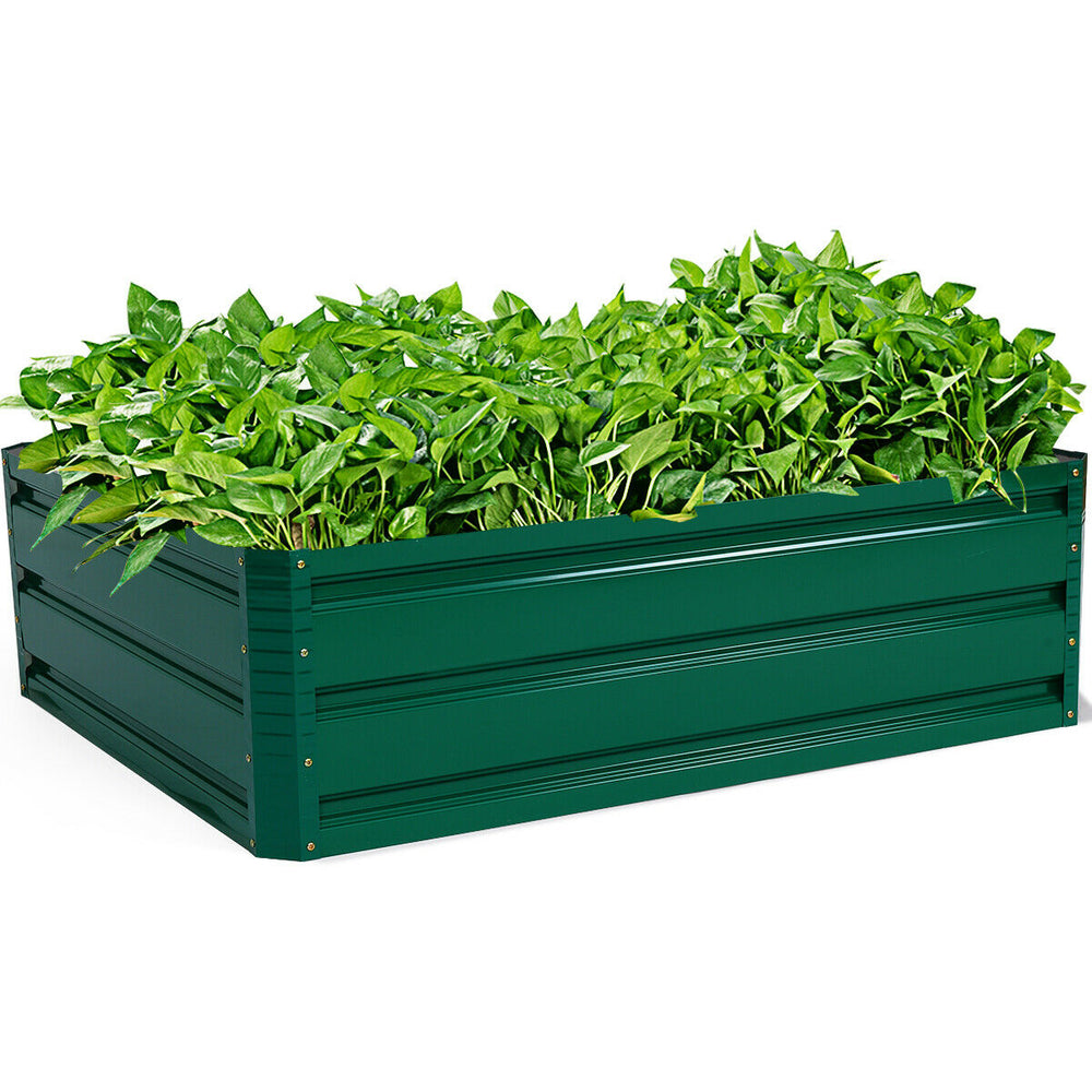 Raised garden bed with vibrant green plants, made of durable steel for vegetable and flower planting in outdoor spaces.