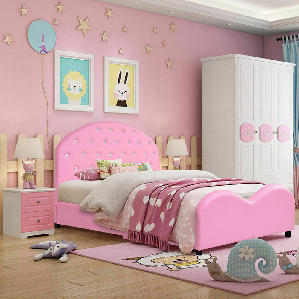 Twin size upholstered toddler bed in pink with rounded edges and wood slat support for safe, comfortable sleeping.