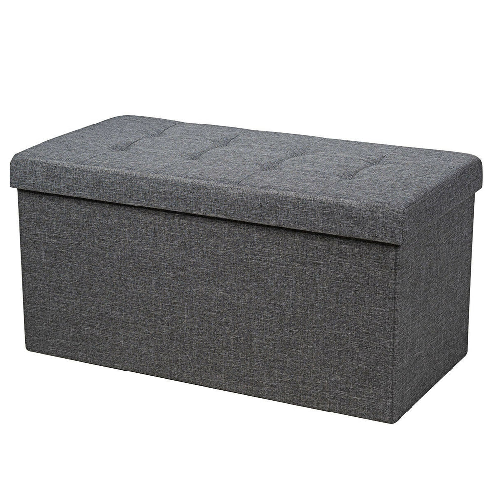 Foldable dark gray storage ottoman with padded seat and roomy interior for blankets, clothes, and shoes. Ideal for any.