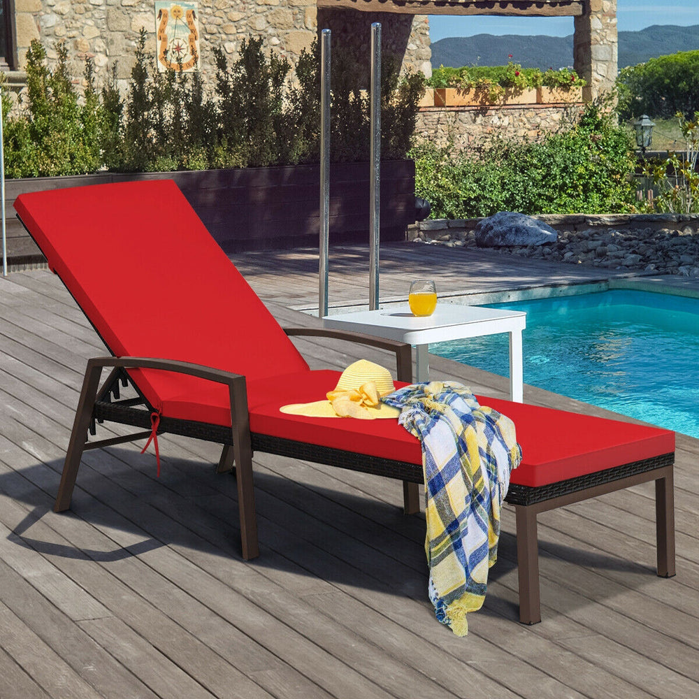 Red cushioned patio rattan lounge chaise recliner with adjustable backrest, perfect for outdoor relaxation by the pool.