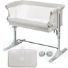 Portable beige baby bedside crib with adjustable heights, detachable sidebar, and carrying bag for easy travel.