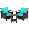 Two turquoise cushioned chairs and a round acacia wood table in a patio rattan furniture set for outdoor relaxation.
