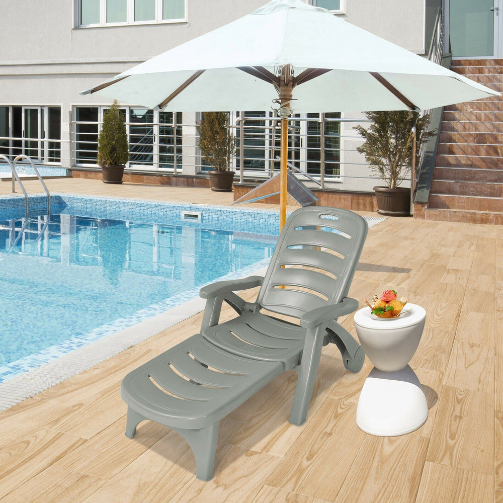 Gray 5-position adjustable folding lounger chaise chair by the poolside, perfect for outdoor relaxation and comfort.