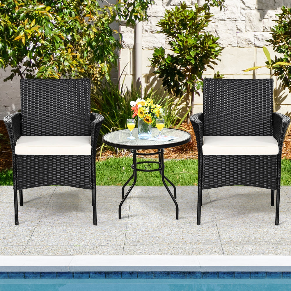 Two patio wicker chairs with cozy seat cushions, featuring a sturdy steel frame, perfect for outdoor relaxation by the.