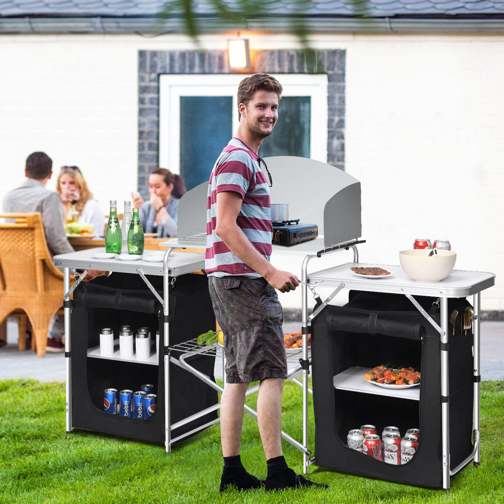 Folding camping table with storage organizer in black, showcasing a heat-resistant tabletop and side tables for outdoor.