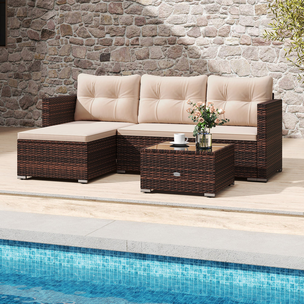 Outdoor wicker furniture set featuring soft beige cushions and a tempered glass coffee table, perfect for poolside.