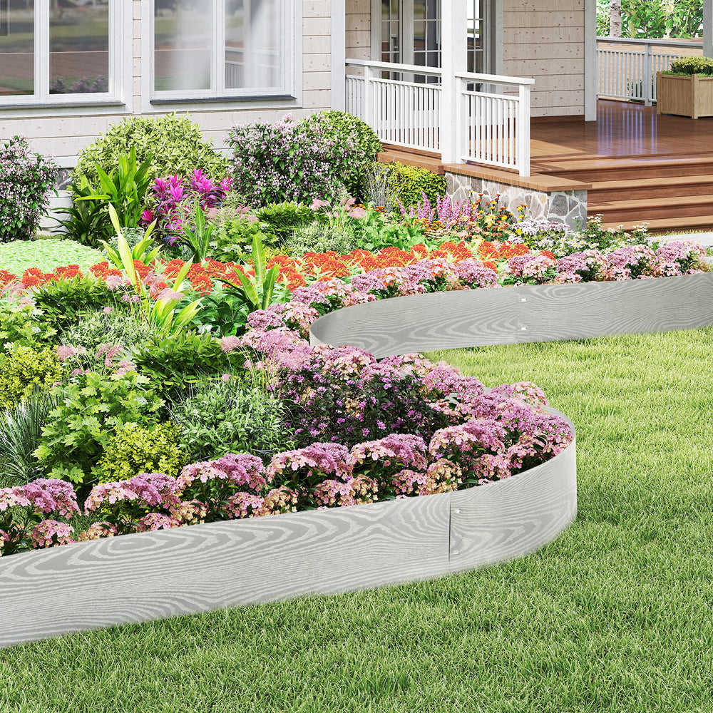Galvanized metal landscape edging in a garden, creating custom shapes and borders for a neat flower bed.