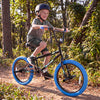 20" trick bicycle for kids with navy frame, 360° steering, adjustable seat, and puncture-proof tires on a forest trail.