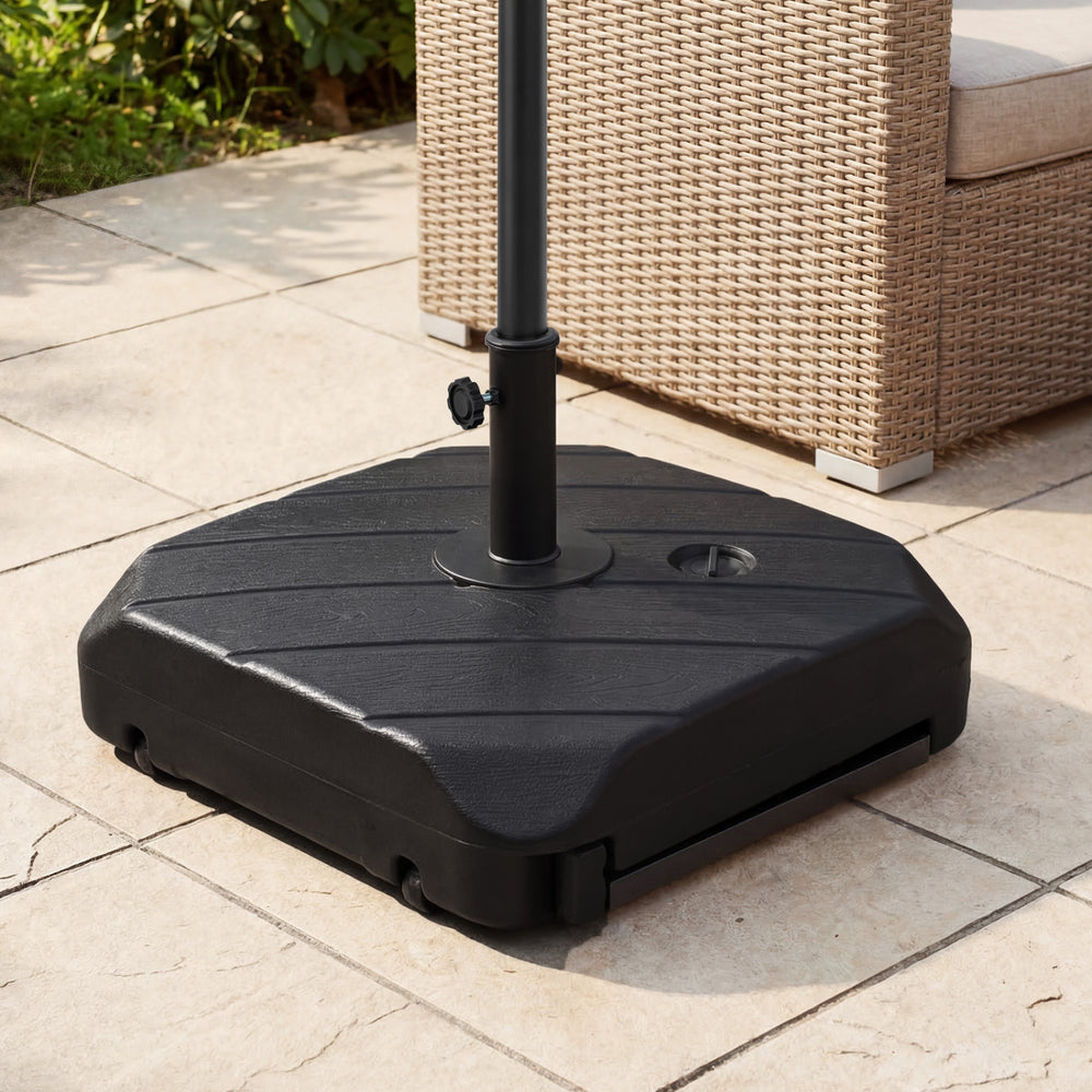 Fillable patio umbrella base with wheels, telescopic pull rod, and wood-grain finish for easy mobility and stability.