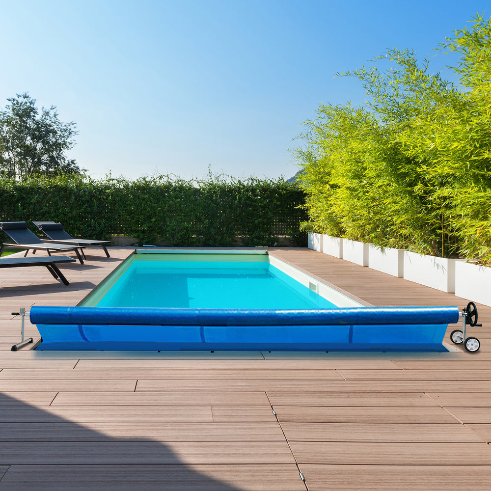 Aluminum pool cover reel set with blue cover, adjustable for in-ground pools 2.5 to 22 feet wide, shown in outdoor.