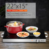 Electric warming tray with heat-resistant glass top, adjustable temperature, ideal for buffets and family dinners.