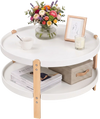 Round 2-tier coffee table with white surface and solid beech legs, featuring an open storage shelf for easy access.