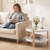 Round 2-tier coffee table with solid beech legs and open storage shelf, perfect for organizing living area essentials.