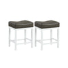 Set of 2 black and white saddle stools with cushioned seats, featuring a solid rubberwood frame for counter height use.