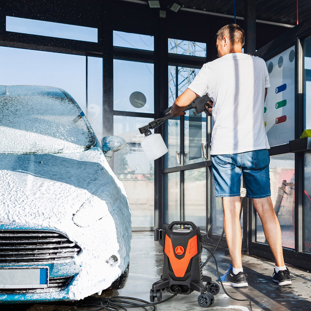 Electric pressure washer with 4 wheels in use, cleaning a car, featuring 2400 PSI and multiple nozzles for versatile.