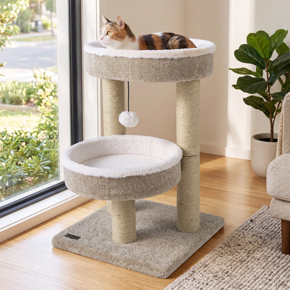Cat tower with two plush perches and scratching posts in beige, featuring a dangling ball for playful cats.
