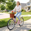 Pink 24-inch beach cruiser bike with woven basket and cup holder, perfect for leisurely rides and flower decoration.