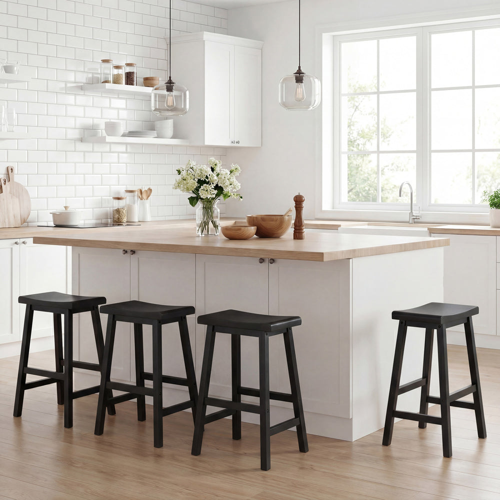 Black 24-inch counter height saddle bar stools with solid wood legs, perfect for kitchen island seating.