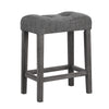 Backless 24-inch gray saddle bar stool with padded seat, button-tufted design, and solid rubber wood frame.